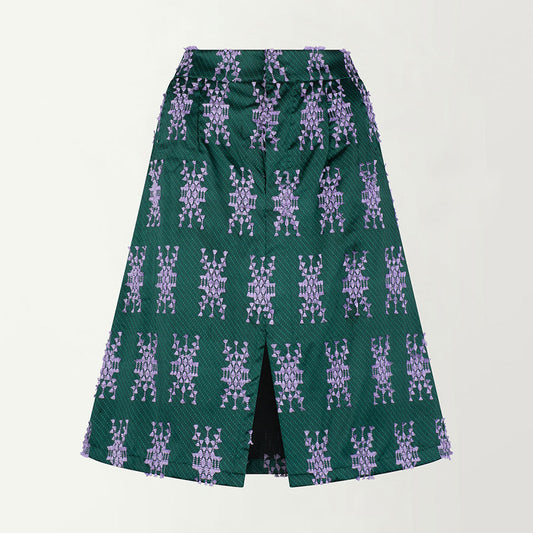 A green skirt with a purple floral tenun pattern, featuring a front slit and side pockets.